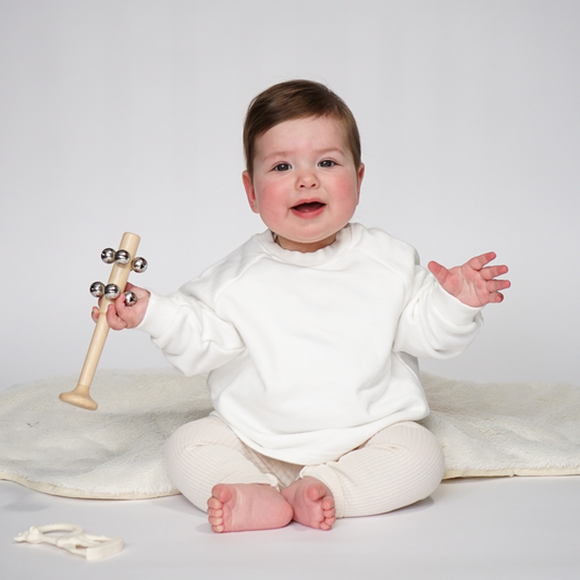 baby in ivory jumper and cream ribbed leggings